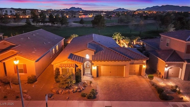 aerial view at dusk featuring a mountain view