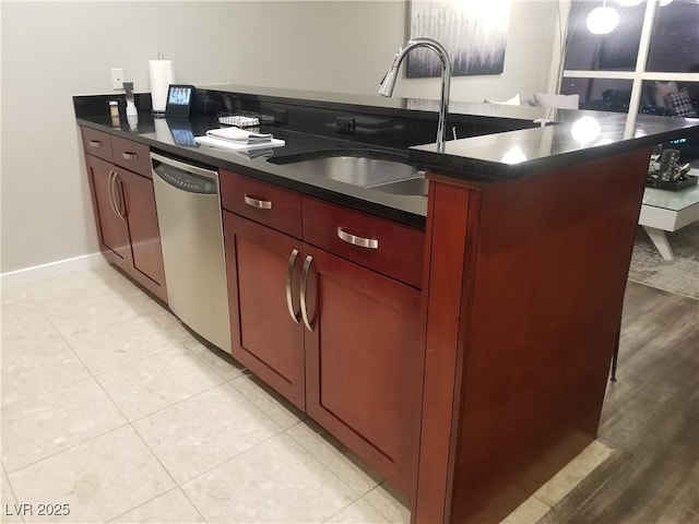 kitchen featuring kitchen peninsula, light tile patterned floors, stainless steel dishwasher, and sink