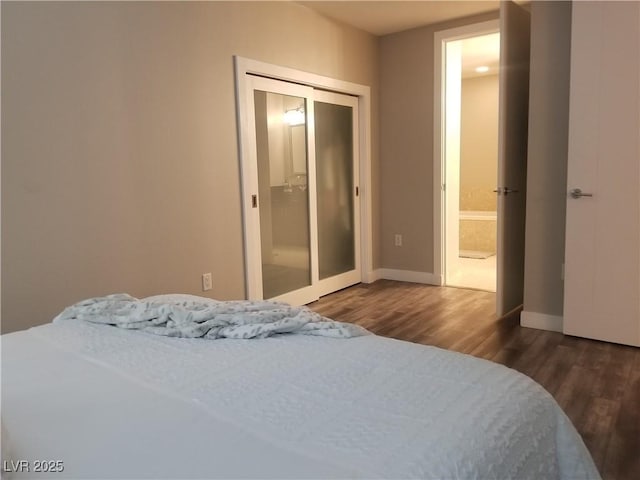 bedroom featuring dark hardwood / wood-style flooring and a closet