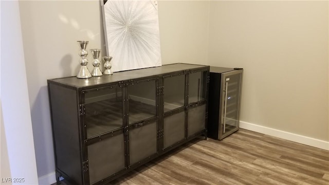 interior details with wine cooler and hardwood / wood-style floors