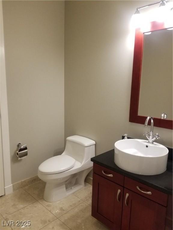 bathroom with tile patterned floors, vanity, and toilet