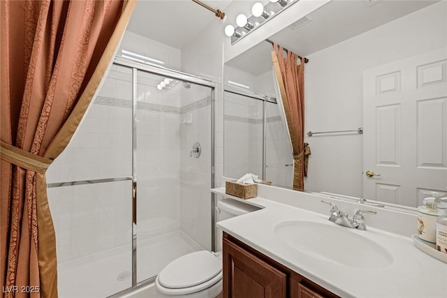 bathroom with vanity, an enclosed shower, and toilet