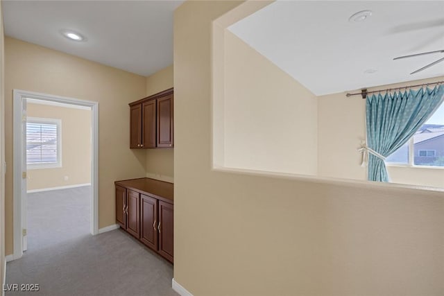 hallway with light colored carpet