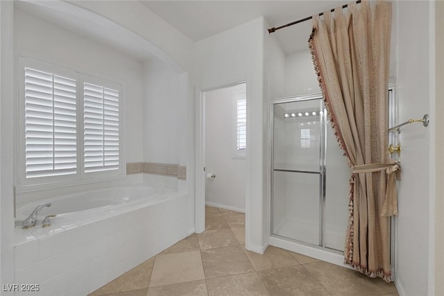 bathroom with tile patterned floors and shower with separate bathtub