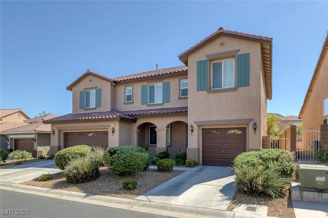 mediterranean / spanish-style home with a garage