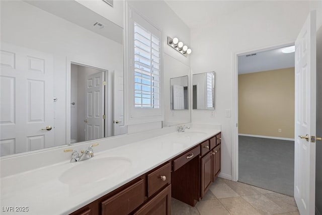 bathroom featuring tile patterned floors, plenty of natural light, toilet, and vanity