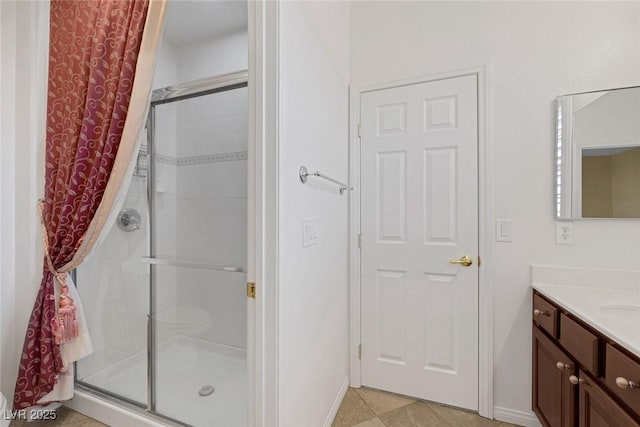 bathroom featuring tile patterned floors, vanity, and an enclosed shower