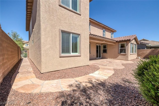 rear view of property featuring a patio