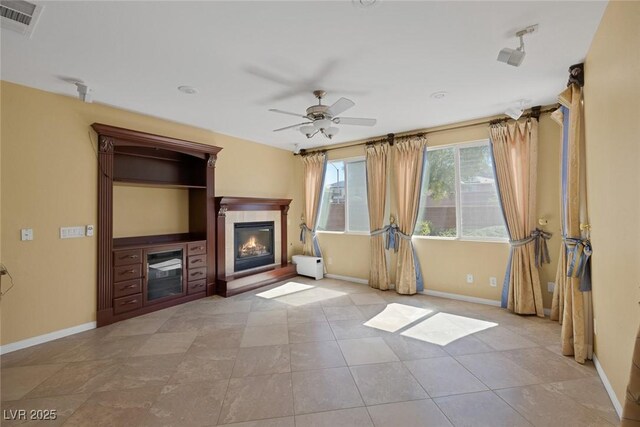 unfurnished living room with ceiling fan and light tile patterned flooring