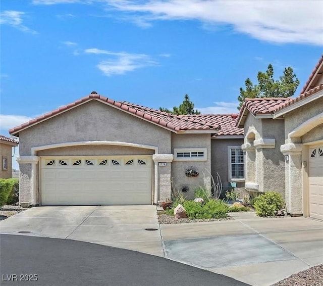 mediterranean / spanish house with a garage