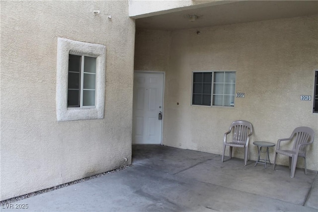 entrance to property with a patio