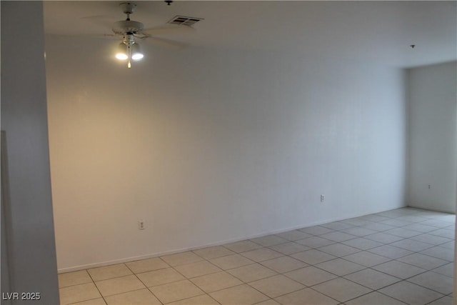 tiled empty room featuring ceiling fan