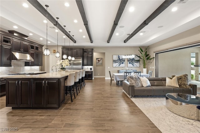 living room with beam ceiling and sink