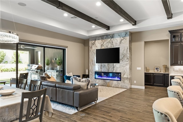 living room featuring a high end fireplace and an inviting chandelier