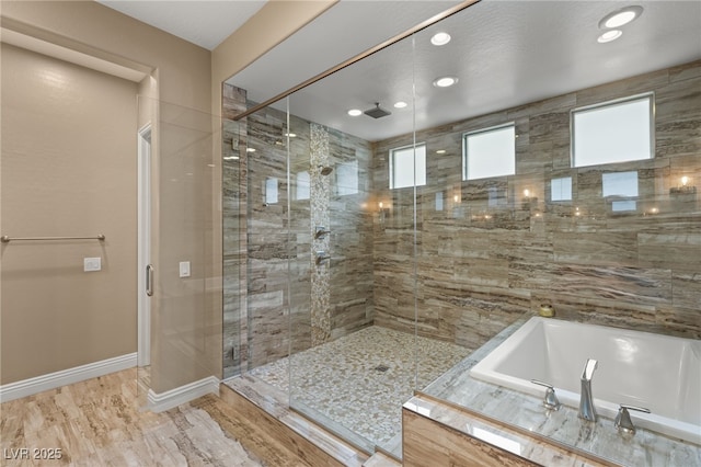 bathroom featuring hardwood / wood-style flooring and separate shower and tub