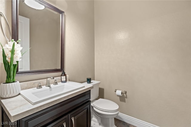 bathroom featuring hardwood / wood-style floors, vanity, and toilet