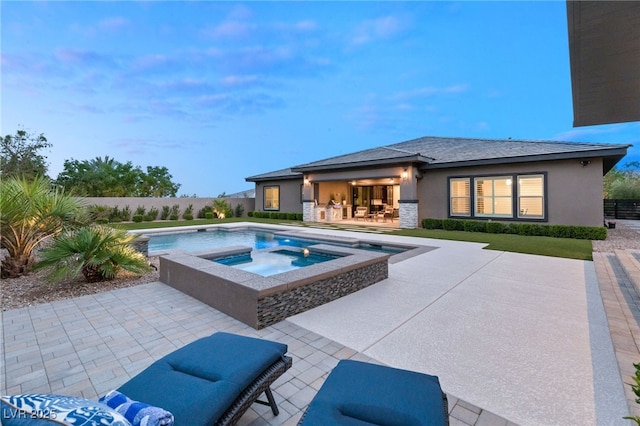 view of pool with a patio area and an in ground hot tub