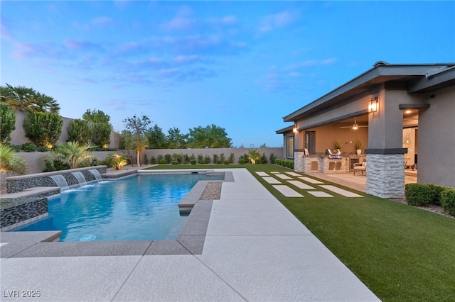 view of pool featuring pool water feature, area for grilling, a yard, and a patio