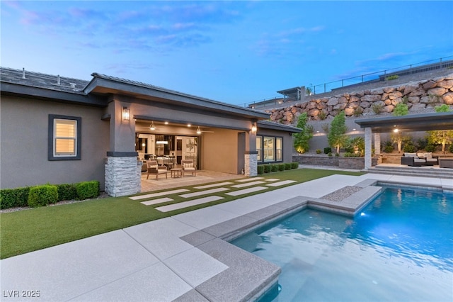 exterior space with an outdoor hangout area and a patio