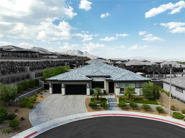 prairie-style house featuring a mountain view and a garage