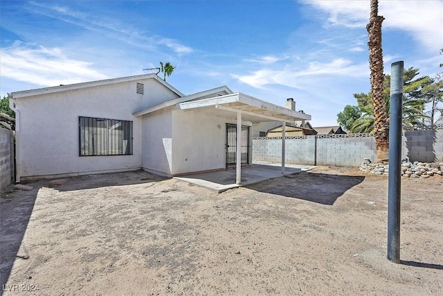 rear view of property featuring a patio