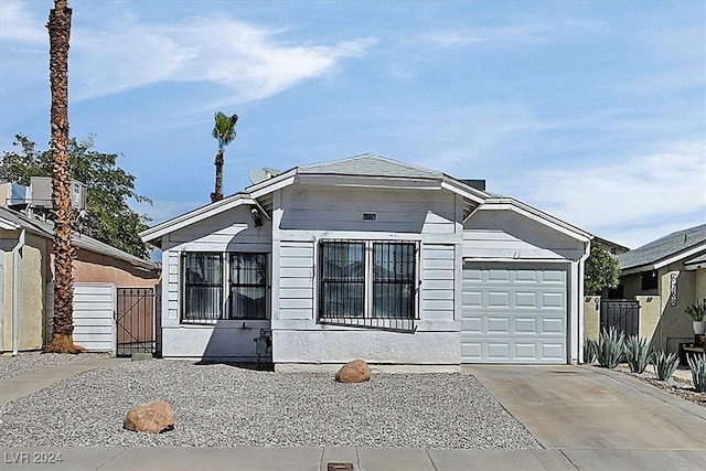 view of front facade featuring central AC unit and a garage