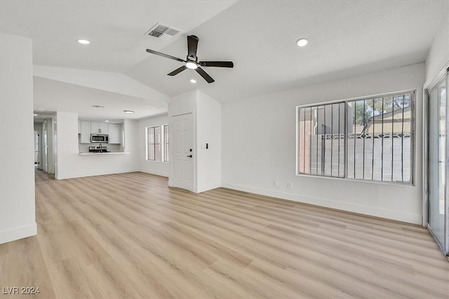 unfurnished living room featuring ceiling fan, light hardwood / wood-style flooring, and vaulted ceiling