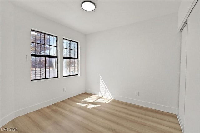 spare room with light wood-type flooring