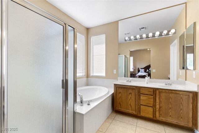 bathroom with tile patterned floors, vanity, and independent shower and bath