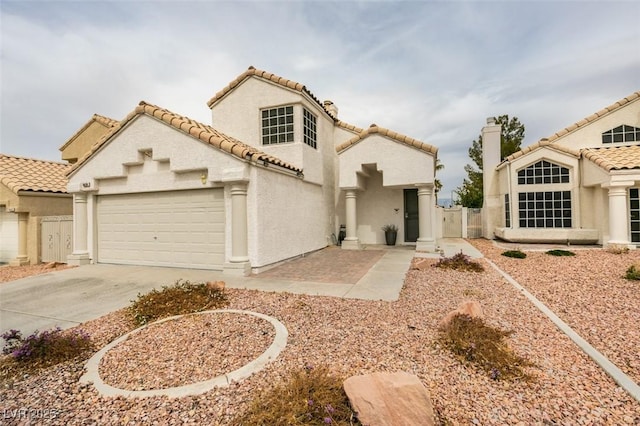 mediterranean / spanish-style home with a garage