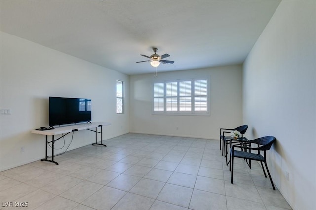 living area featuring ceiling fan and light tile patterned floors