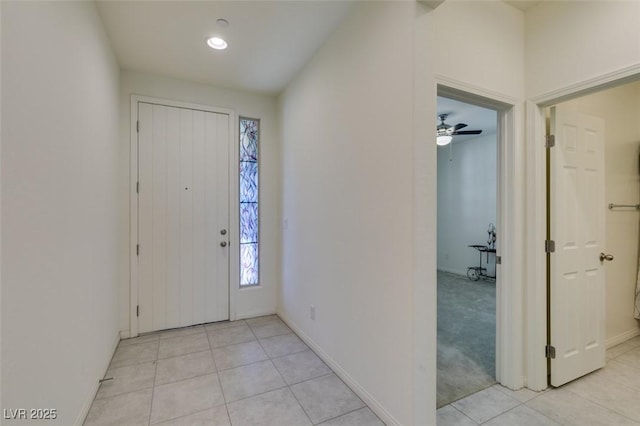 tiled entrance foyer with ceiling fan