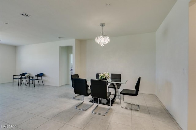 dining space featuring light tile patterned flooring and a chandelier