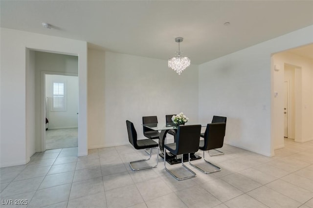 dining space with a notable chandelier and light tile patterned flooring