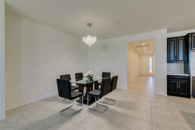 dining room with light tile patterned floors and an inviting chandelier