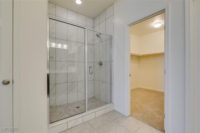 bathroom with walk in shower and tile patterned flooring