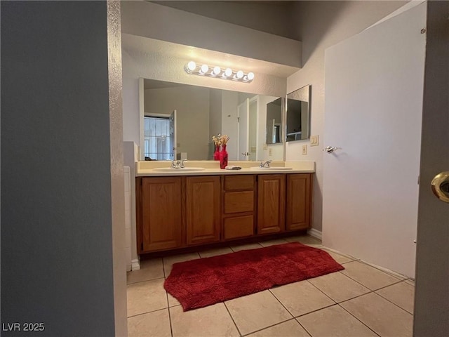 bathroom with tile patterned flooring and vanity