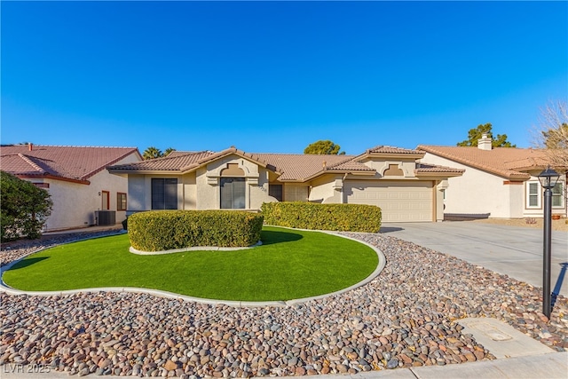 mediterranean / spanish home with a garage and a front lawn