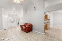 living room with ceiling fan and light tile patterned floors