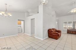 living room with light tile patterned floors and an inviting chandelier