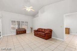 living area with ceiling fan, light tile patterned flooring, and vaulted ceiling