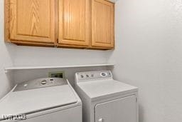 laundry area with cabinets and washing machine and dryer