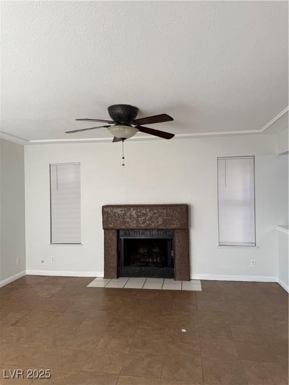 unfurnished living room with a textured ceiling, ceiling fan, and a fireplace