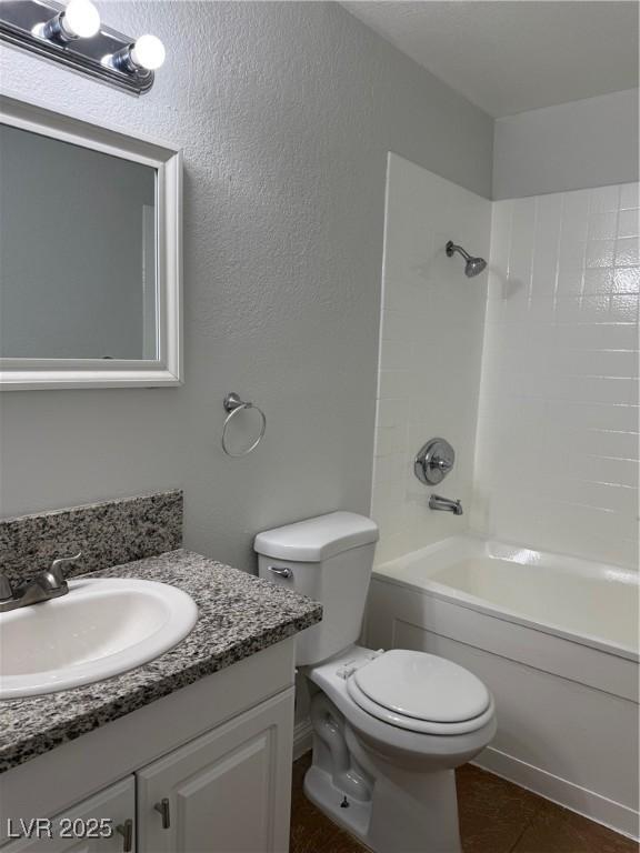 full bathroom with toilet, vanity, tile patterned floors, and tub / shower combination