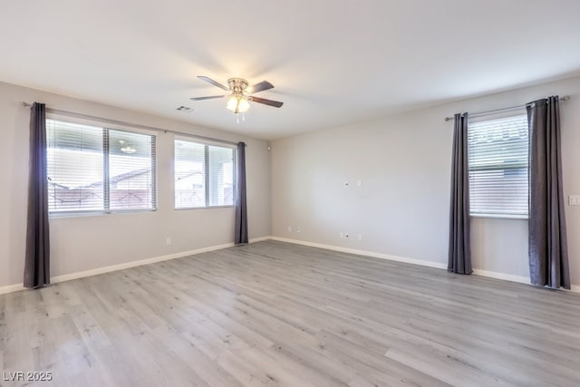 empty room with light hardwood / wood-style floors and ceiling fan