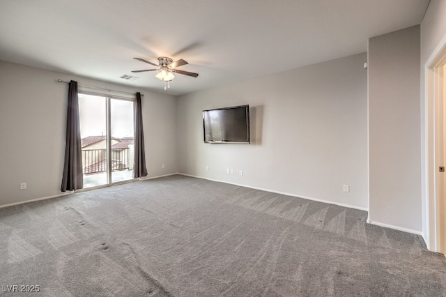 spare room featuring carpet and ceiling fan