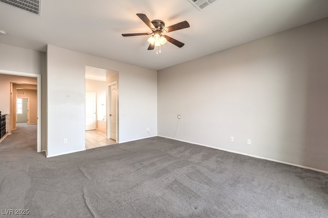 unfurnished bedroom featuring ceiling fan, light colored carpet, and ensuite bathroom