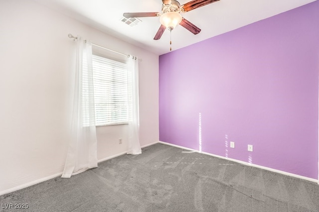 unfurnished room featuring ceiling fan and carpet