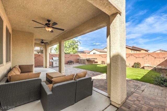 view of patio / terrace with an outdoor living space, an outdoor kitchen, ceiling fan, and a grill