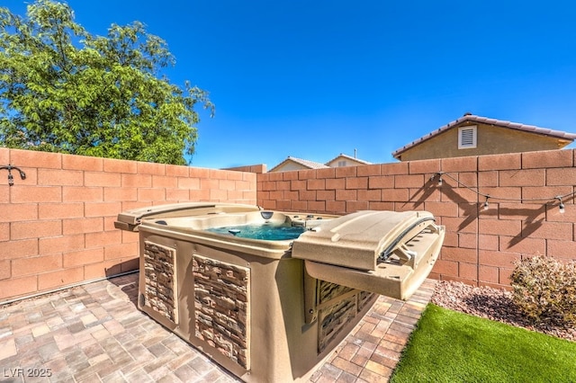 view of patio with a hot tub